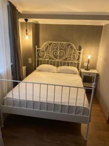 a bedroom with a white bed with a wrought iron headboard at Kinzi House in Canakkale