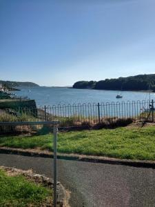 a pole on the side of a road near a body of water at The Old Court House & Jail in Menai Bridge