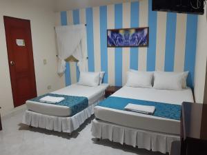 Ein Bett oder Betten in einem Zimmer der Unterkunft Hotel El Andino