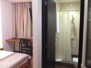 a bedroom with a bed and a bathroom with a shower at Hotel Club-2100 in Gudauri