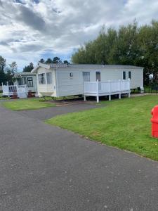 a mobile home with a fire hydrant in front of it at Seton sands static holiday home - sleeps 6 in Port Seton