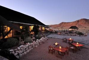 a resort with tables and chairs in the desert at Sandfontein Lodge & Nature Reserve in Sandfontein