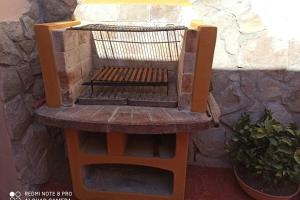 a wooden bench sitting next to a stone wall at Villino Iris in Quartu SantʼElena