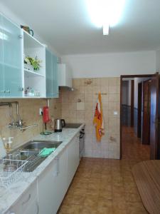 a kitchen with a sink and a counter top at Apartamento Solvita in Coimbra