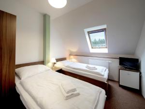 Postel nebo postele na pokoji v ubytování Penzion na Křižánkách