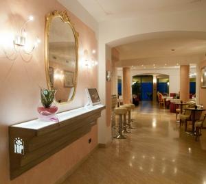 a hotel lobby with a mirror and a restaurant at Hotel Panorama Ristorante ***S in Torri del Benaco