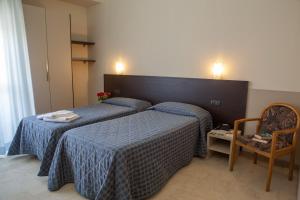 a hotel room with two beds and two night stands at AUTO PARK HOTEL con Ristorante interno e grande parcheggio gratuito in Florence
