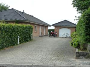 a house with two bikes parked next to a driveway at Snehvide Bed & Breakfast in Thisted