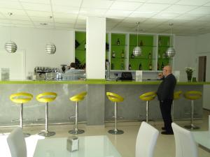 a man standing at a counter in a restaurant at Residencia Mayol - Adults Only in Palma de Mallorca