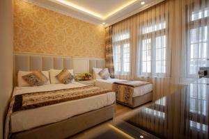 a bedroom with two beds and a window at Best Nobel Hotel in Istanbul