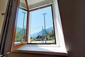 a window with a view of a mountain at Apartma Sašo in Srpenica