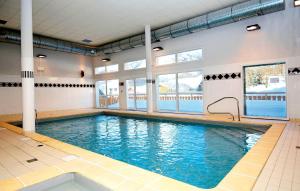 a swimming pool in a gym with blue water at travelski home select - Résidence Les Bergers in Saint-Sorlin-dʼArves