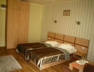 Postel nebo postele na pokoji v ubytování Hotel Stogu