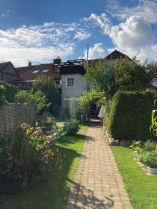 a garden with a brick path in front of a house at Emmerglück Lügde in Lügde