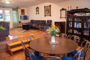 a living room with a table and chairs at Penzion Holacký in Dolní Dunajovice
