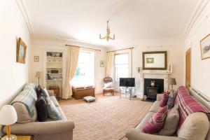 a living room with a couch and a fireplace at Whitehaven in North Berwick