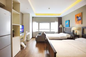Postel nebo postele na pokoji v ubytování Yashi International Aparthotel