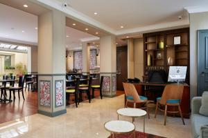 a restaurant with tables and chairs and a bar at Garden Saint Martin in Paris