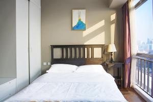 Postel nebo postele na pokoji v ubytování Yashi International Aparthotel