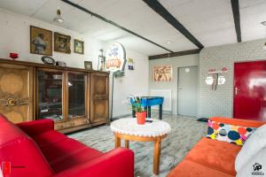 a living room with a red couch and a table at Apartamenty na Podhalu in Nowy Targ