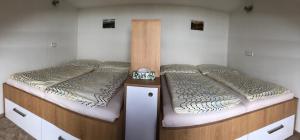 A bed or beds in a room at Loučná - Apartmán Daňovi