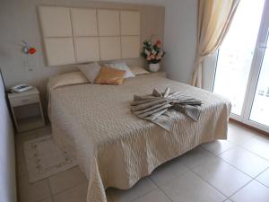Un ou plusieurs lits dans un hébergement de l'établissement Hotel Toscana