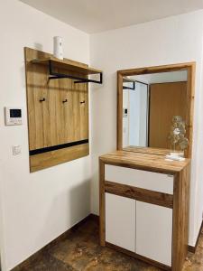a bathroom with a wooden counter and a mirror at Luxuriöses und modernes Apartment zum Wohlfühlen in Zirl