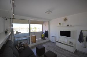 a living room with a couch and a television at STUDIO VUE PORT ET MER in Valras-Plage
