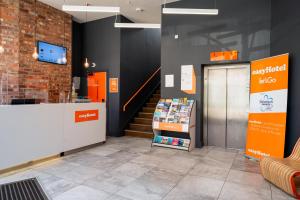 a store lobby with a checkout counter and a staircase at easyHotel Birmingham in Birmingham