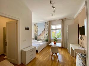 a bedroom with a bed and a desk and a chair at B&B Vila Teslova in Ljubljana