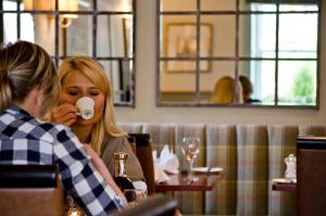 a woman talking on a cell phone in a restaurant at The Parliament House Hotel in Edinburgh +32 photos