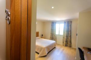 Postel nebo postele na pokoji v ubytování Hotel Cesario