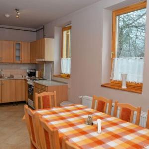 a kitchen with a table and chairs in a room at Noszvaj Elite Apartman in Noszvaj