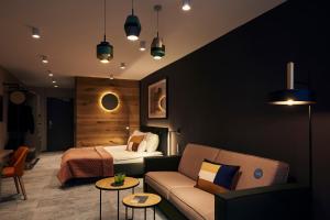 a hotel room with a bed and a couch at Mountains Hotel in Seefeld in Tirol