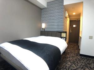 Ліжко або ліжка в номері APA Hotel Machidaeki-Higashi
