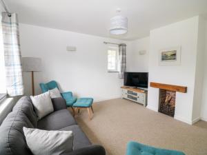 a living room with a couch and chairs and a television at Summercourt in Launceston