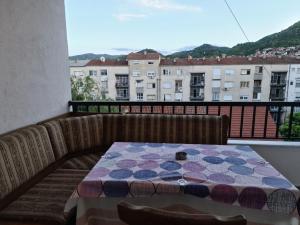a table on a balcony with a view of a building at City Center Apartments in Strumica