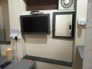 a flat screen tv on the wall of a room at Budget Hotel in Patna