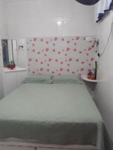 a bedroom with a bed with red flowers on the wall at Apartamento Centro de Convenções in Recife