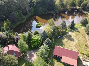 an aerial view of a house and a river at Dom Nad Stawem in Rakszawa