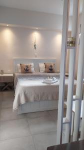 a bedroom with a large bed in a room at Happy Anchor Apartments in Kallithea Halkidikis