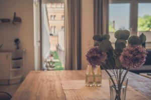 un jarrón con flores en él sentado en una mesa en Stadtblick en Lüneburg