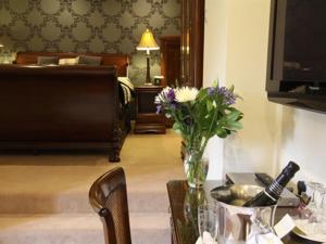 a living room filled with furniture and a table at Mansion House Hotel in Elgin