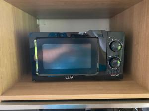 a tv and a speaker sitting on a shelf at Bungalov v Beskydech in Frenštát pod Radhoštěm