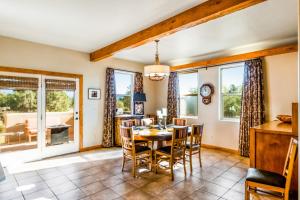 a dining room with a table and chairs and windows at Pagosa Peak View in Pagosa Springs