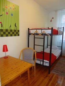 a bed room with a bunk bed and a desk at Red Nose Hostel in Riga