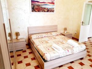 a bedroom with a large bed with two night stands at Duomo Central Loft in Naples