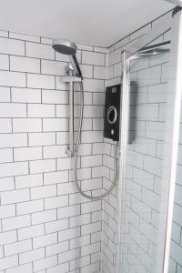 a shower with a shower head in a bathroom at The Annexe - private, self-contained with parking in Southampton