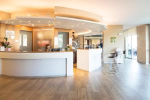 a lobby of a building with a reception counter at Garda Hotel Forte Charme in Nago-Torbole