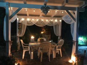 a table and chairs under a pergola with lights at Il Trullo di Nonno Angelo San Marco in Locorotondo